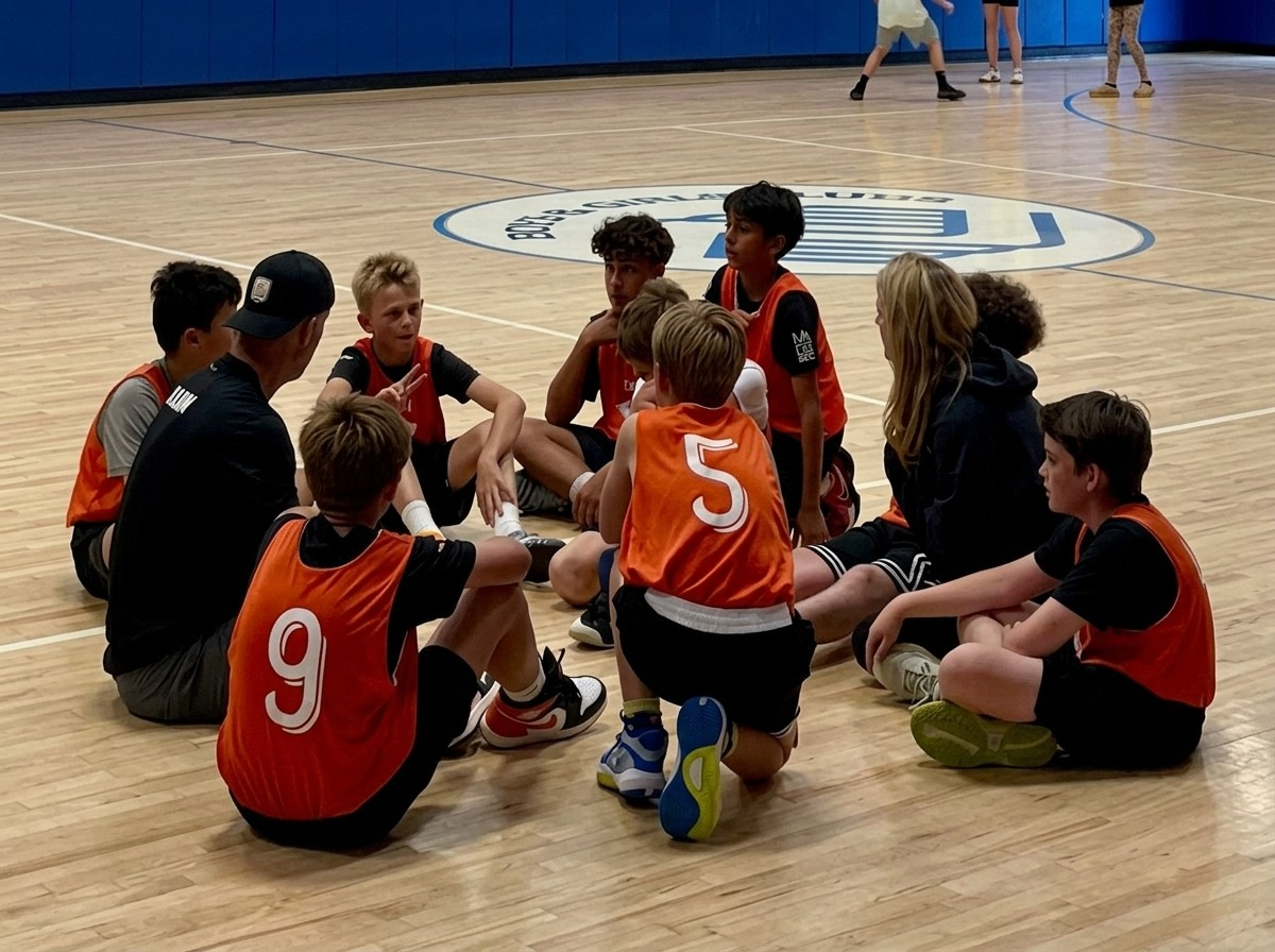 Andrew Hahn coaching a youth basketball team in a huddle